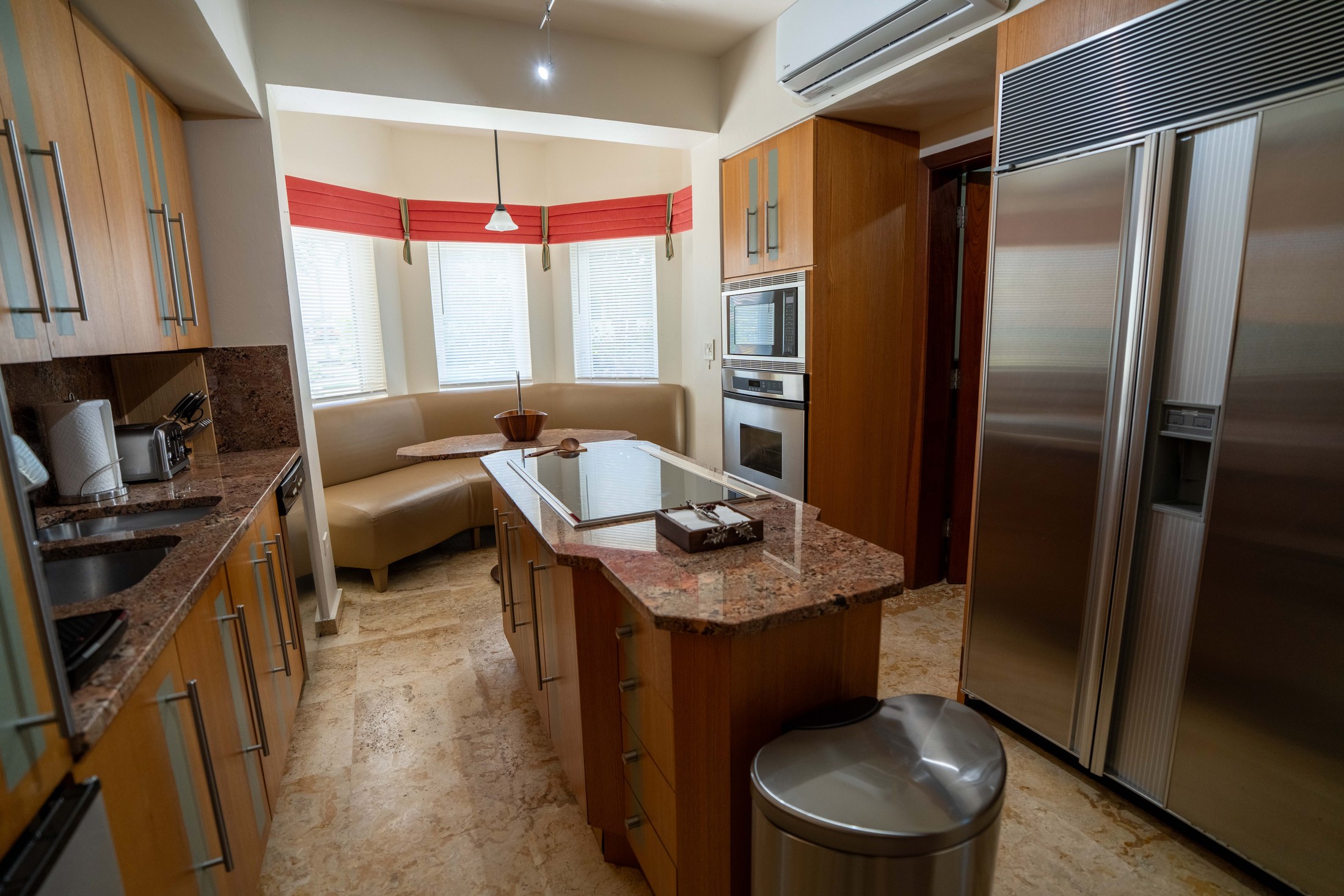 Full kitchen with island and stainless appliances
