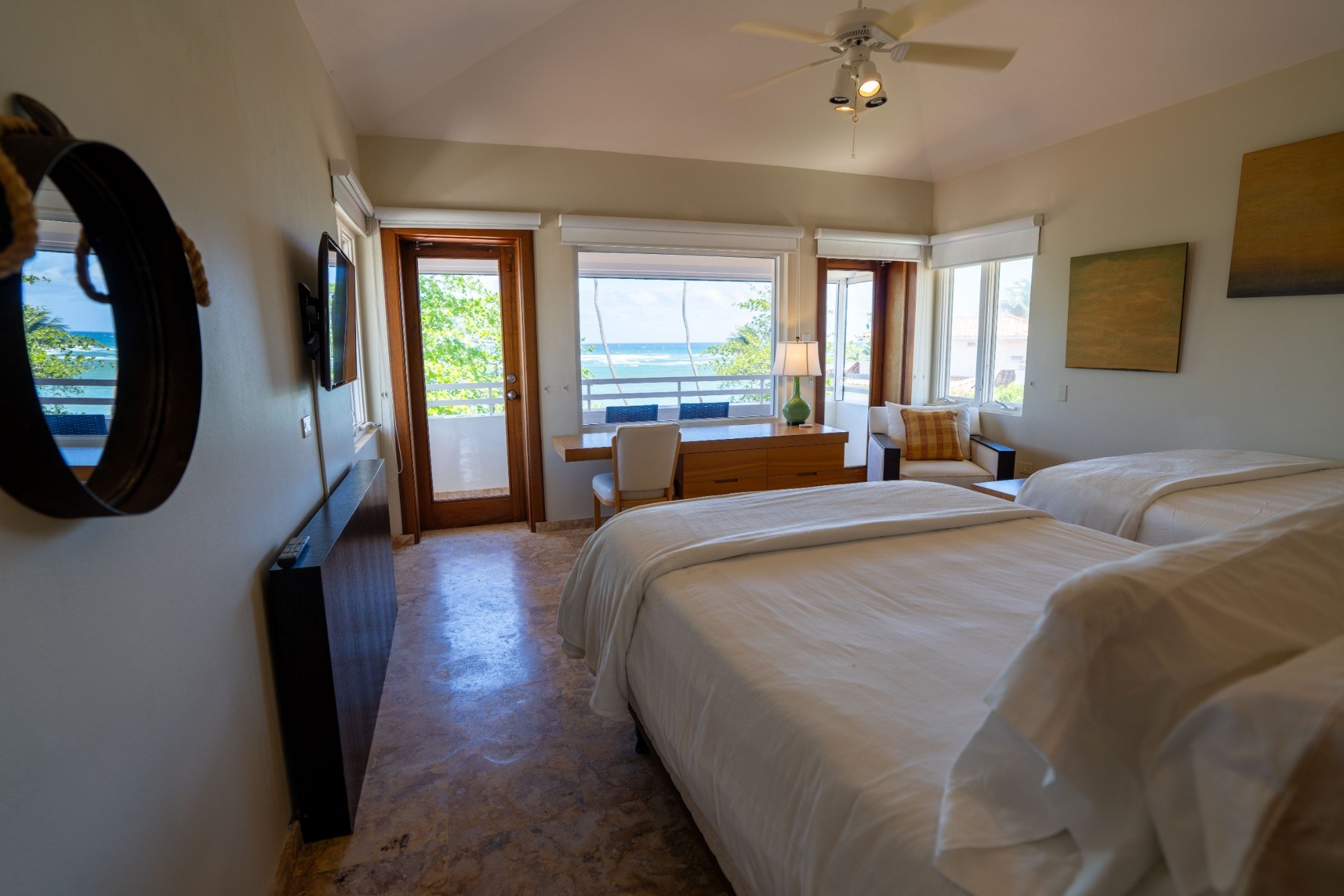 Third-floor bedroom with two queen beds and ocean-view balcony