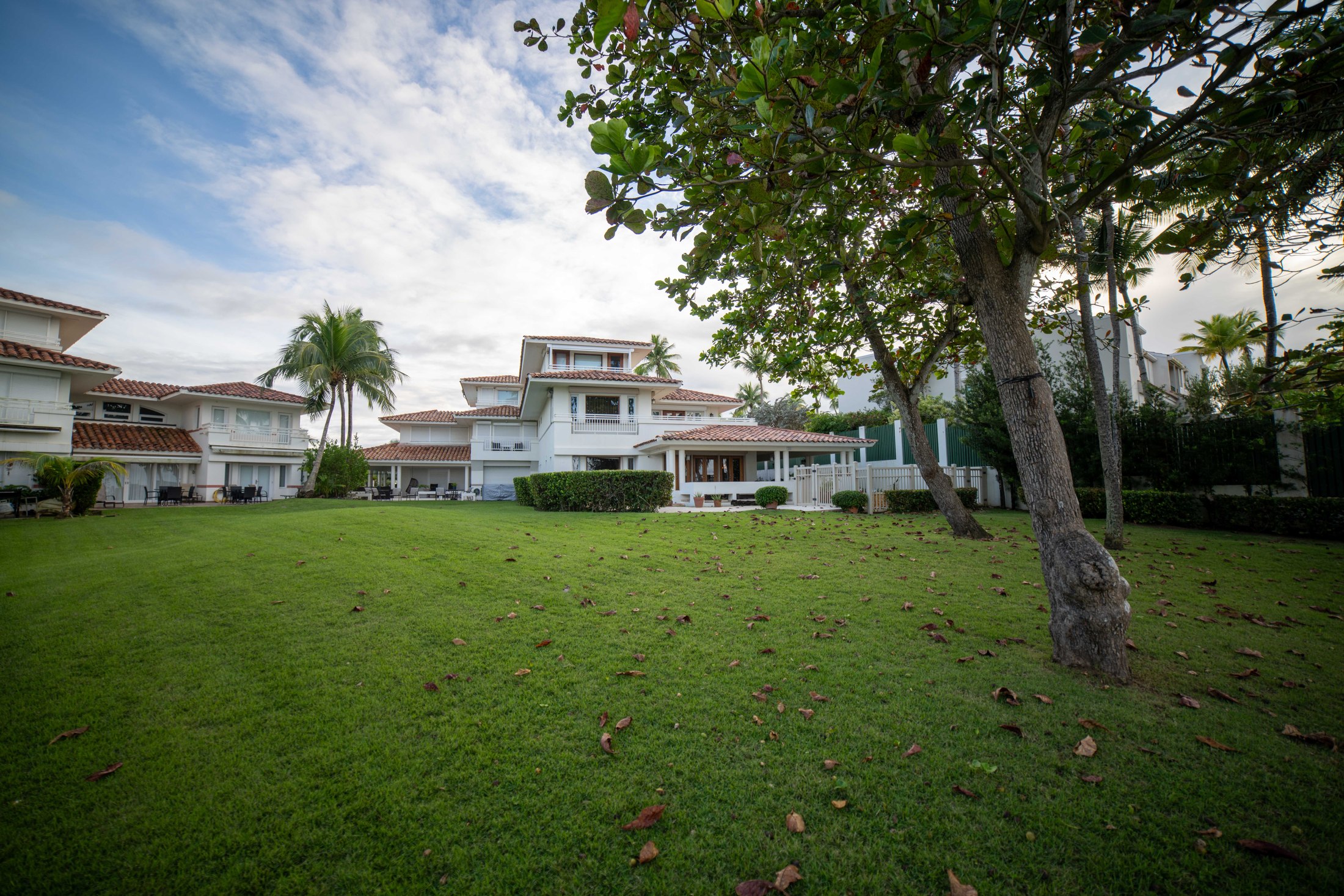 Villa Paraíso seen across its green oceanfront lawn