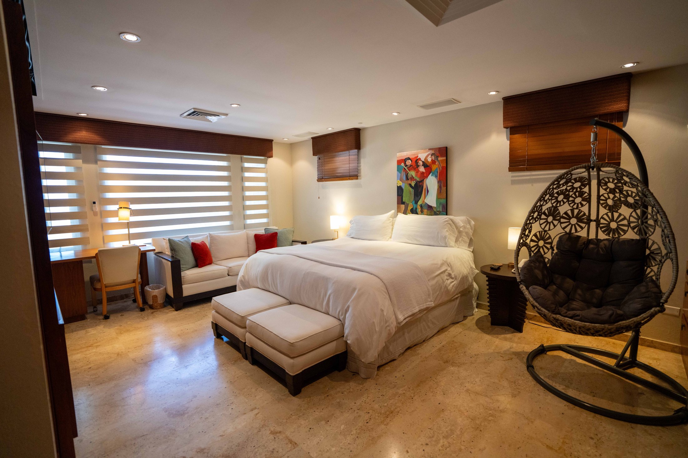 First-floor master bedroom with king bed and seating area