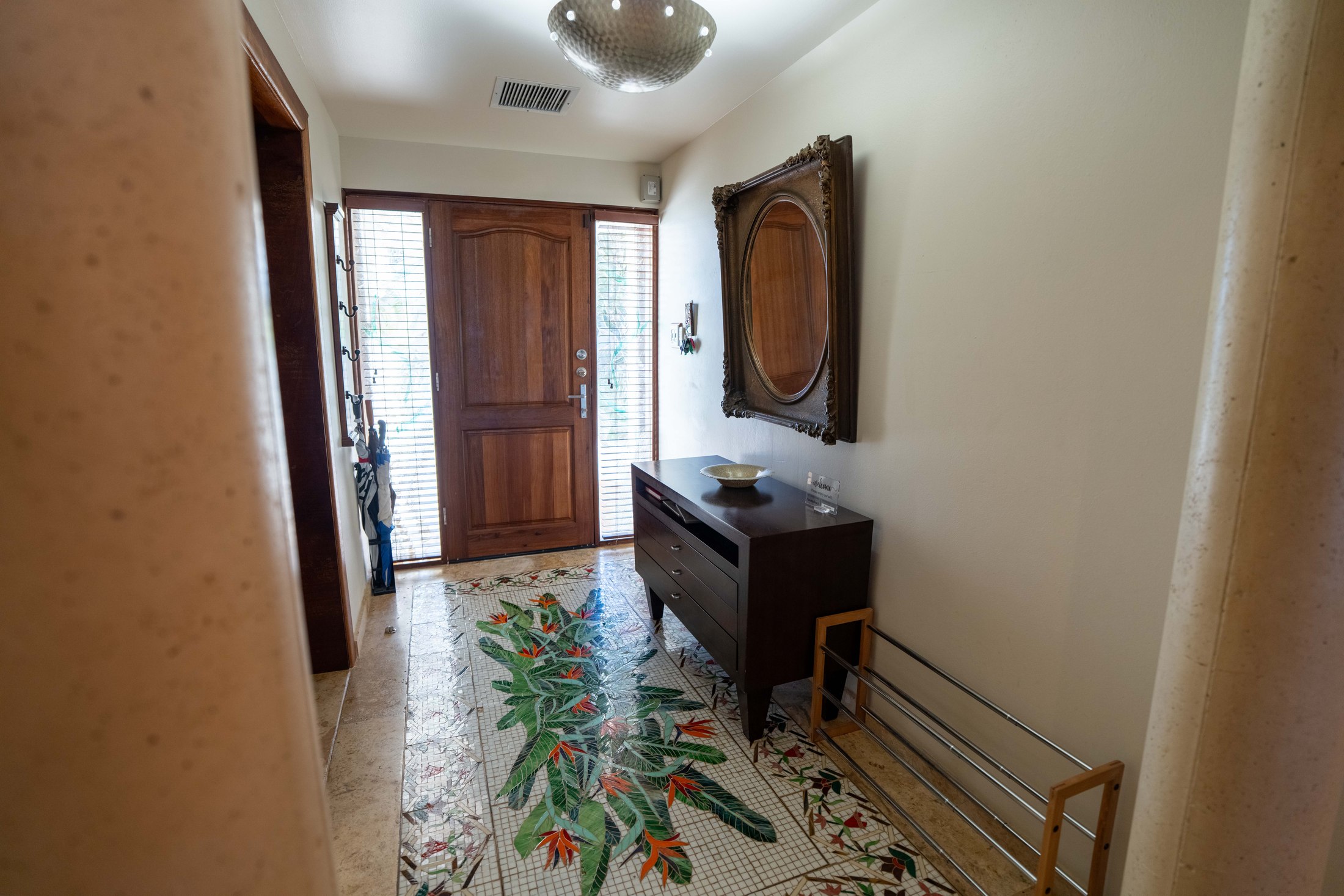 Foyer and front entrance interior with mosaic tile floor